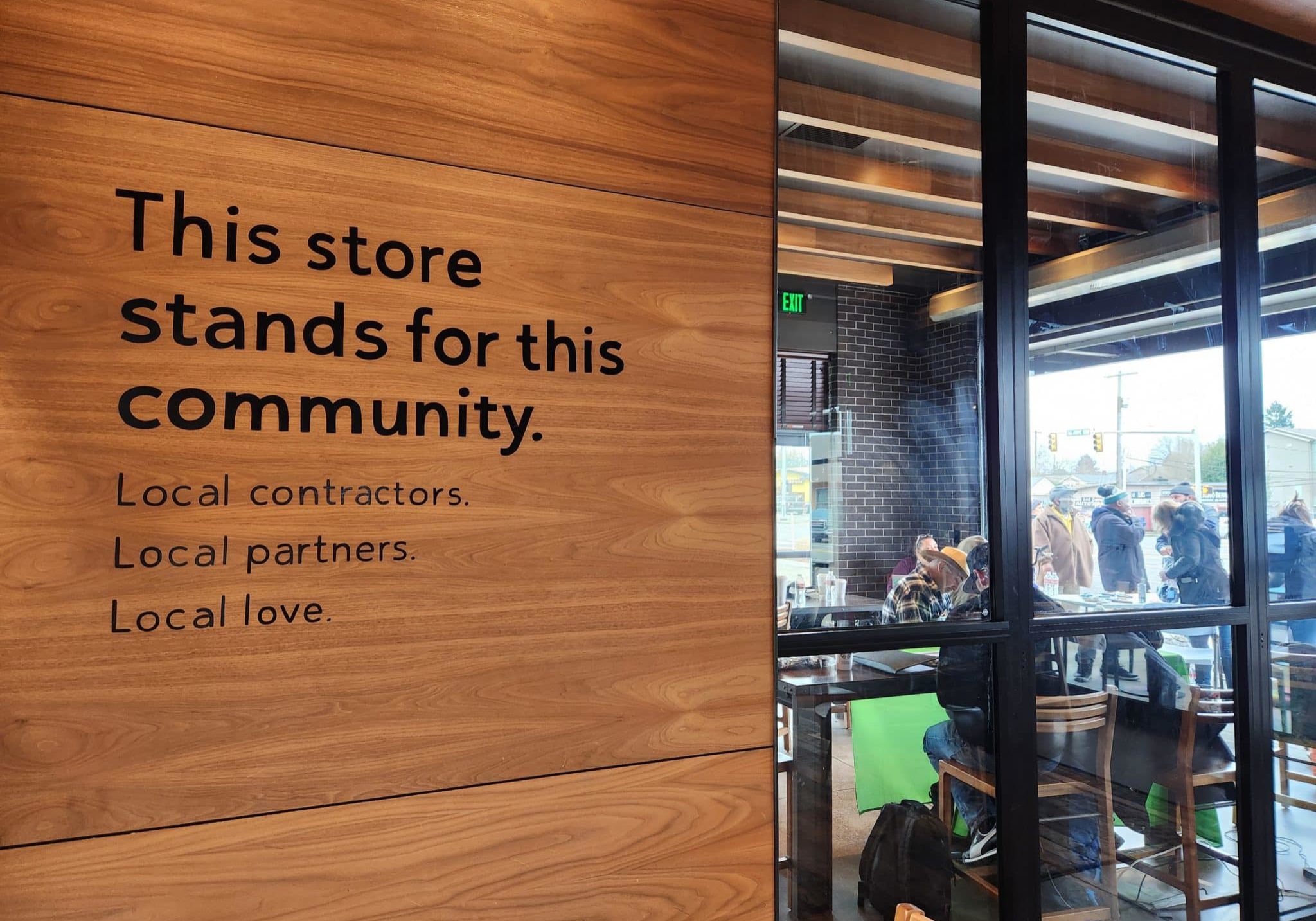 Lettering on a Starbucks wall saying, "This store stands for this community."