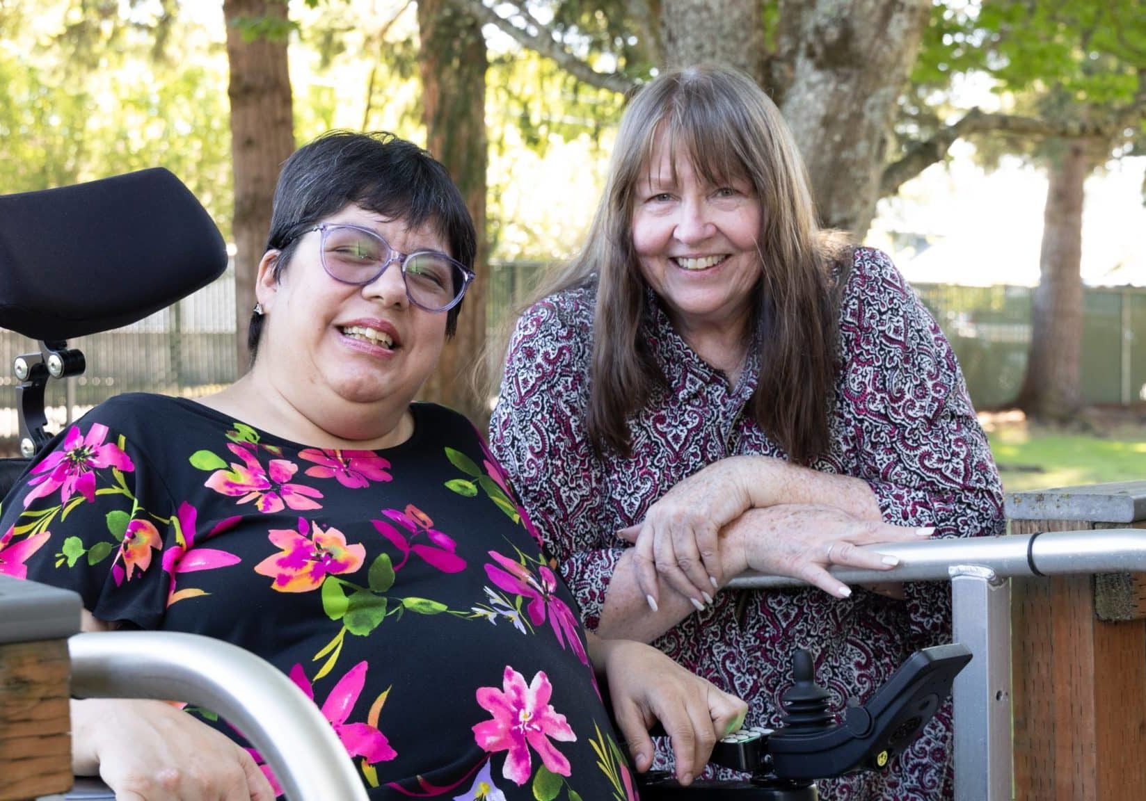 Lena and her caregiver, Cathy, smiling.
